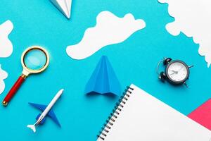 Paper plane on a blue background with clouds photo