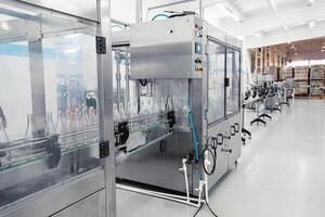Advanced bottling machine operates in a modern beverage manufacturing facility during daylight hours photo