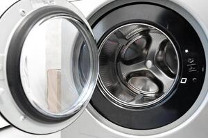 Washing machine with open door showcasing interior drum and control panel features for laundry tasks photo