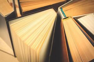Old and used hardback books or text books seen from above. photo