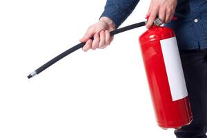 Man using fire extinguisher isolated on white photo