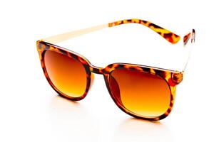 Sunglasses in leopard frame isolated on white background photo