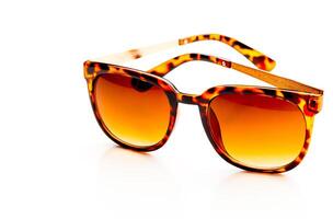 Sunglasses in leopard frame isolated on white background photo