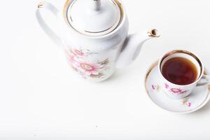 Cup of tea with teapot in vintage style photo