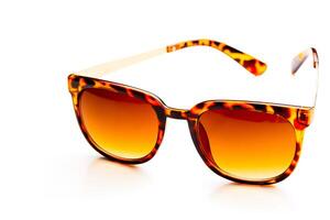 Sunglasses in leopard frame isolated on white background photo