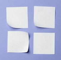 Blank paper tag label or sticker with copy space - flat lay on violet desktop background photo
