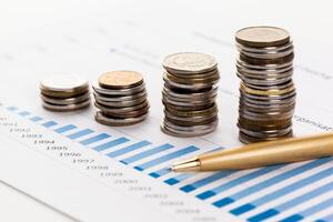 Graph Of Stock Market With Stacks Of Coins photo
