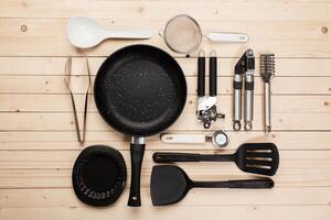 cookware and accessories on a wooden table. photo