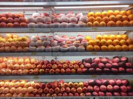 fresh fruits displayed on supermarket shelves photo