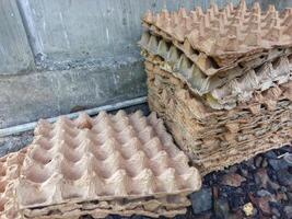 stack of used egg racks made from cardboard photo