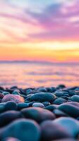 Colorful sunset over a tranquil beach with smooth pebbles lining the shore reflecting vibrant hues of purple and orange photo