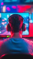 A gamer immersed in a colorful setup with headphones, enjoying a late-night gaming session at home photo