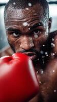 Intense boxer training indoors, focused expression, droplets of sweat flying, wearing red gloves, captured during a rapid punching sequence photo