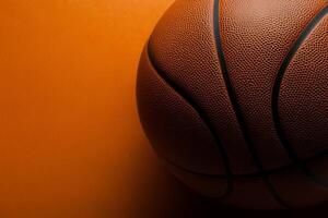 A close-up view of a basketball resting on an orange surface, emphasizing its textured surface and vibrant color photo