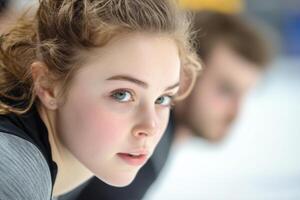 Young athlete practicing ice skating indoors at a rink during winter training session with focused expression photo