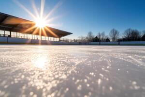 Sunny afternoon at an outdoor ice rink with a clear blue sky and scenic surroundings during winter in a local community photo