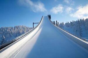 Winter sports ski jump ramp surrounded by snow-covered trees on a clear day photo