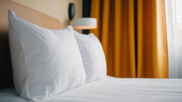 Cozy hotel room with soft white pillows and warm curtains in the late afternoon light photo