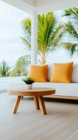 Bright and airy living room with a white sofa and orange cushions surrounded by tropical greenery and natural light photo