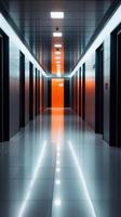 A modern hotel corridor with glowing lights leading to a bright orange door at night photo