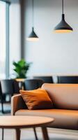 Modern seating area with ambiance lighting in a contemporary lounge, featuring a plush sofa and green plants during daylight hours photo