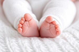 Sweet tiny baby feet resting on a soft blanket at home during a cozy afternoon photo