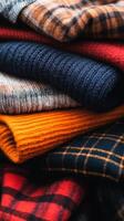 A vibrant collection of freshly folded knitted sweaters stacked neatly on a soft background ready for autumn wear photo