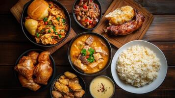 A vibrant assortment of Asian-inspired dishes served on wooden table with rice and various meats during dinner time photo