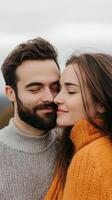 A couple embraces overlooking a scenic landscape during a cloudy day in autumn, sharing a moment of love and connection photo