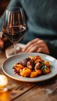 A cozy dinner featuring gourmet gnocchi and red wine at an intimate restaurant during an autumn evening photo