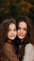 A joyful moment between a mother and daughter outdoors in the fall, captured during a warm sunset in a serene natural setting photo