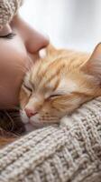 A woman cuddling her orange cat on a cozy winter day at home, showcasing warmth and affection in a serene indoor setting photo