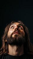 Blind man with white eyes and long hair and beard looking up on dark background photo
