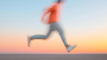 A person runs along the beach at sunset, creating a blurred motion effect that captures the joy of movement and energy photo