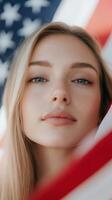 Young woman poses confidently with American flag in the background, celebrating patriotism and unity during a sunny day photo