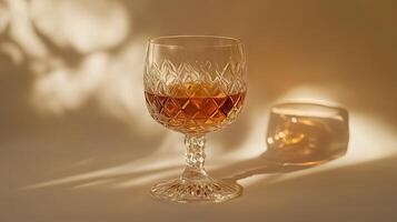 Golden Amber Drink in a Faceted Crystal Glass photo