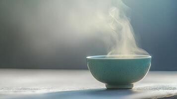 A Delicate Teal Bowl of Steaming Hot Soup photo