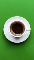A Simple Cup of Coffee on a Green Background photo