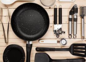 cookware and accessories on a wooden table. photo