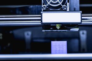 head of 3d printer in action photo