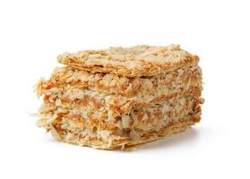 Delicious layers of crispy oat biscuits stacked elegantly on a white background showcasing texture and design photo