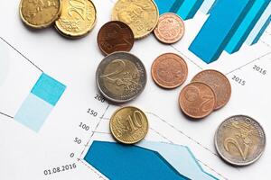 Graph Of Stock Market With Stacks Of Coins photo
