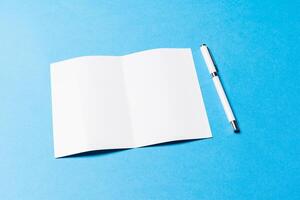 blank office objects organized for company presentation on blue paper background photo