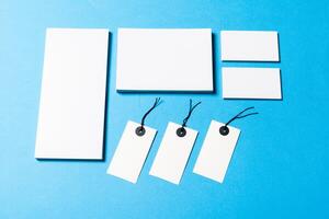 blank office objects organized for company presentation on blue paper background photo