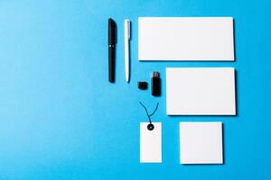 blank office objects organized for company presentation on blue paper background photo