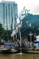 A striking monument in Surabaya featuring a crocodile and a shark intertwined in a dramatic pose, symbolizing the city name and history, Indonesia, 12 January 2025 photo
