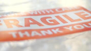 This is a Fragile Package Warning Label that includes a Care Message video