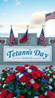Celebration of Tetann's Day with vibrant flowers and flags at a memorial site during a sunny day photo