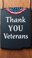 Sign expresses gratitude to veterans with patriotic decoration and wooden background photo