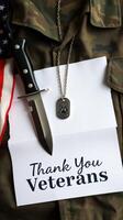 Tribute to Veterans with Military Gear, Dog Tags, and Thank You Note Displayed on Camo Uniform photo